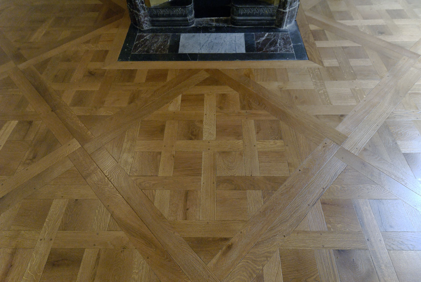 Aged patined finishing for this oak parquet floor Versailles