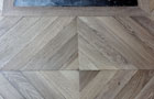 Closeup of  the changing direction of the Chevron parquet floor
