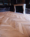 Chevron parquet floor front of his fireplace